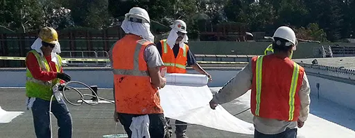 Angelus workers installing a Cool Roof on a commercial building in Anaheim, CA
